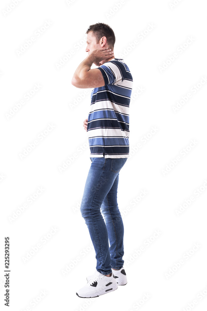 Side view of young adult casual man with hand on neck having neck pain. Full body isolated on white background. Side view of young adult casual man with hand on neck having neck pain. Full body isolated on white background.