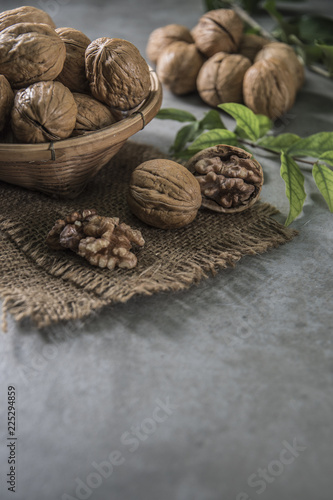 Walnuts in wooden bowl. Whole walnut on table