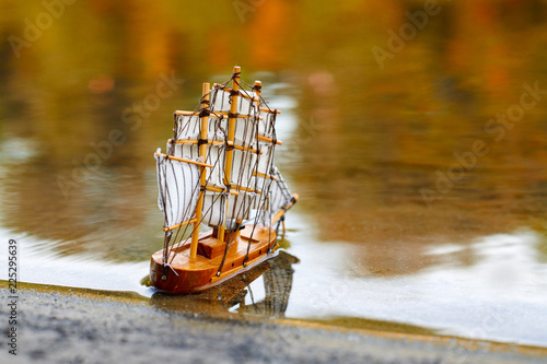 a toy sailing ship in the river