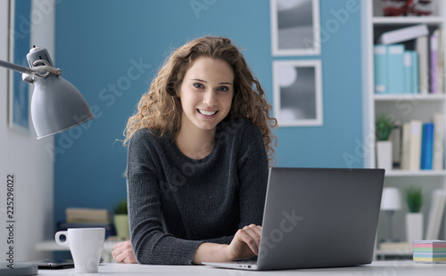 Young woman connecting with her laptop