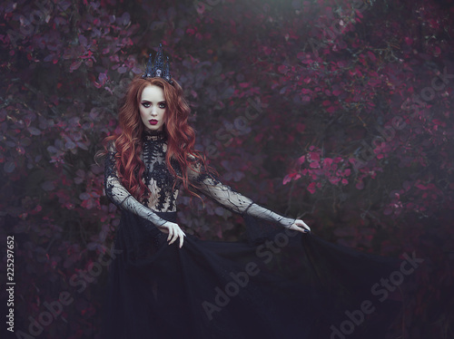 A beautiful gothic princess with pale skin and long red hair wearing a crown and a black dress against the backdrop of burgundy leaves.