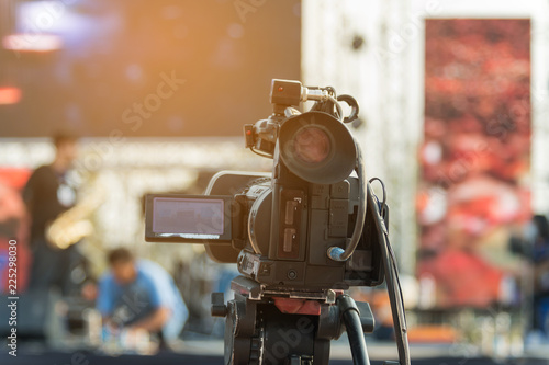 Video production covering event on stage by professional video camera in outdoor concert