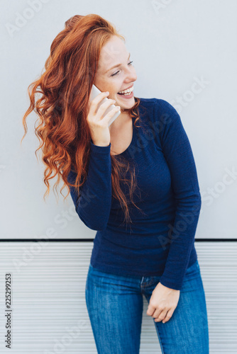 Smiling young woman talking on mobile phone
