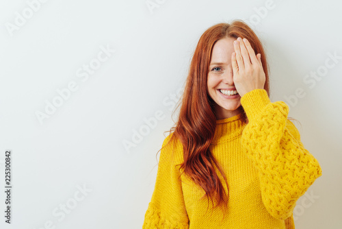 Happy smiling woman covering on eye