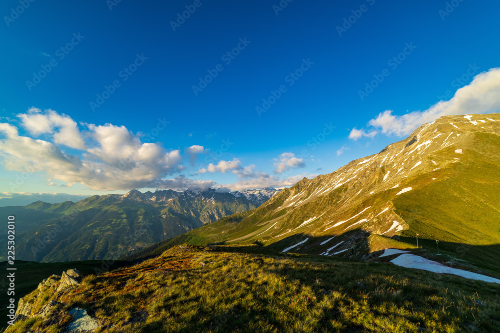 Obraz premium Dramatic sunset scene in high mountains. Clouds covering high peaks of Valais Alps (Pennine Alps), Switzerland in a evening light.