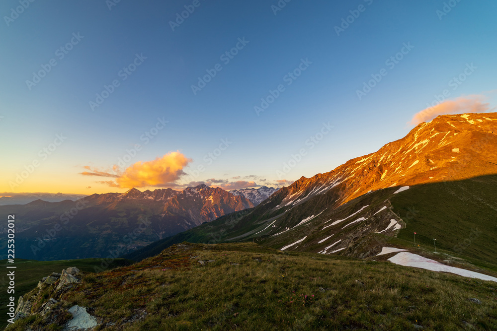 Obraz premium Scenic view of beautiful landscape of Swiss Alps in a Val De Bagnes area. Dramatic sunset scene in high mountains.