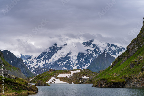 Scenic view of Lac de Louvie - mountain lake above Val de Bagnes valley, Switzerland. Lake surrounded by high mountains.