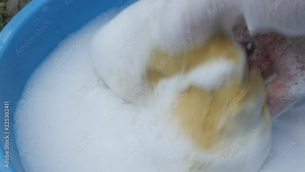 Sinking sponge in detergent and preparing for car wash 4K footage Sinking sponge in detergent and preparing for car wash 4K footage