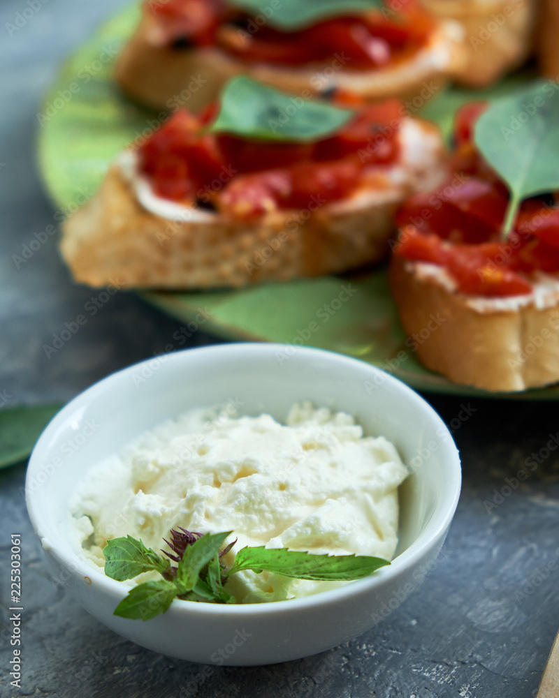 Italian bruschetta with chopped tomatoes, basil and cheese on grilled crusty bread Italian bruschetta with chopped tomatoes, basil and cheese on grilled crusty bread