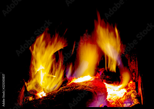 Bright burning firewood in the brazier, hot flame on a dark background