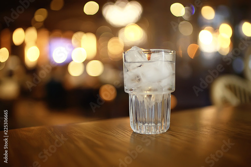 glass of water with ice in the restaurant / cold clear clear water in a glass with ice pieces