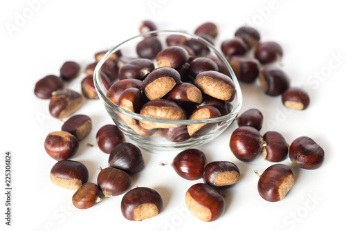 pile of chestnuts in a transparent glass bowl isolated  