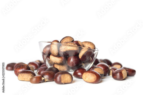 pile of chestnuts in a transparent glass bowl isolated
