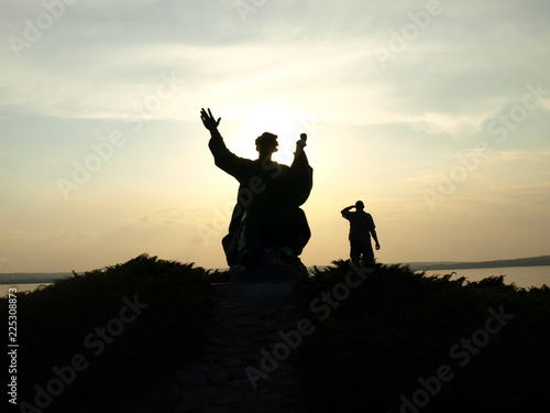 Silhouette of a monument and man on sunset