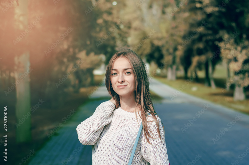 Beautiful woman female bag sweater smile in the street sun nature Beautiful woman female bag sweater smile in the street sun nature