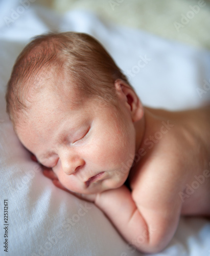 Newborn baby peacefully sleeps in his room