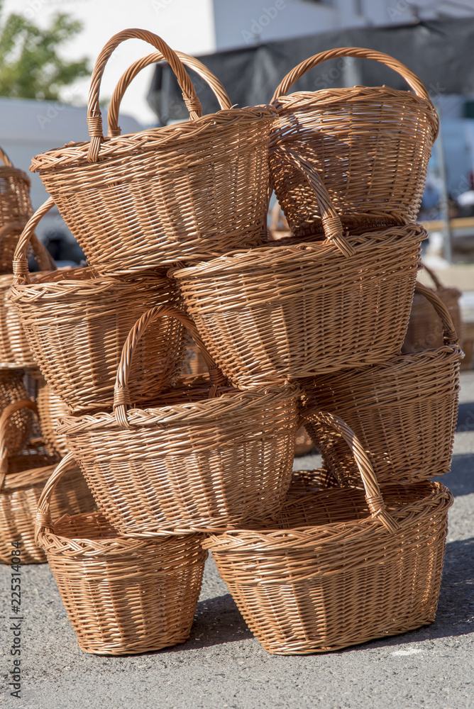 Baskets for sale stacked on top of each other Composition in a traditional fair with artistic hand-made packaging Baskets for sale stacked on top of each other Composition in a traditional fair with artistic hand-made packaging