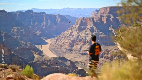 Grand Canyon, Arizona - view from top down to the river colorado. Someone taking pictures and walking around.