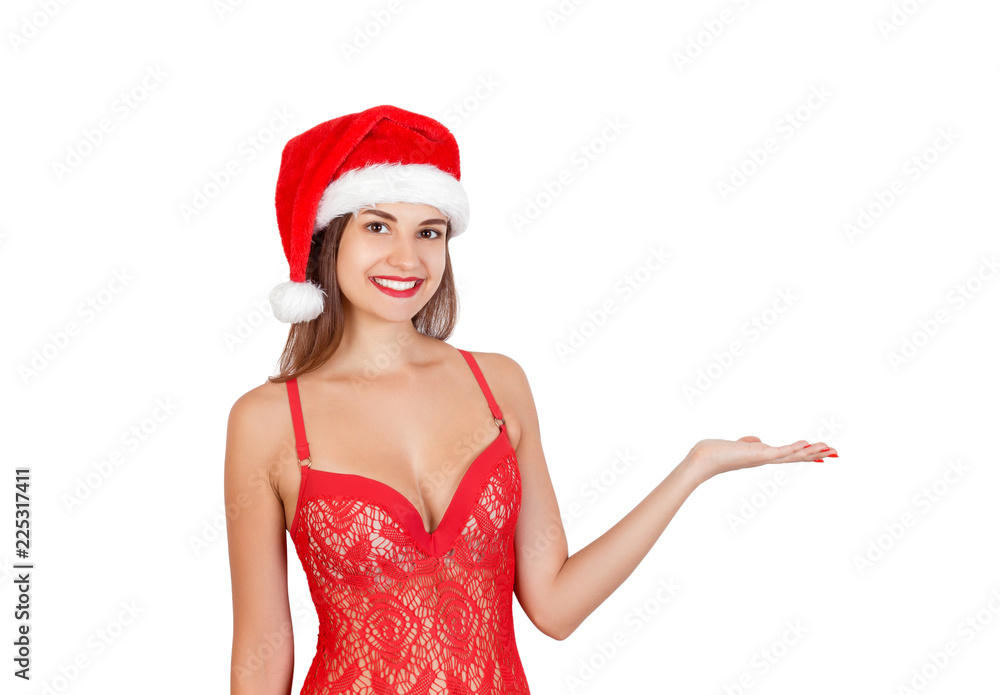 Young beautiful girl in swimsuit and christmas hat with palm up and place your product here. Recommend advertising concept. emotional woman in red santa claus hat isolated on white background Young beautiful girl in swimsuit and christmas hat with palm up and place your product here. Recommend advertising concept. emotional woman in red santa claus hat isolated on white background