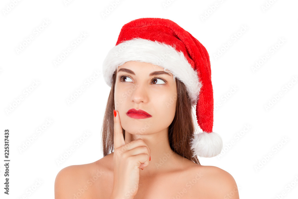 portrait of thinking and reflecting girl in a Christmas hat. emotional woman in red santa claus hat isolated on white background. Happy Christmas and New Year holidays concept portrait of thinking and reflecting girl in a Christmas hat. emotional woman in red santa claus hat isolated on white background. Happy Christmas and New Year holidays concept