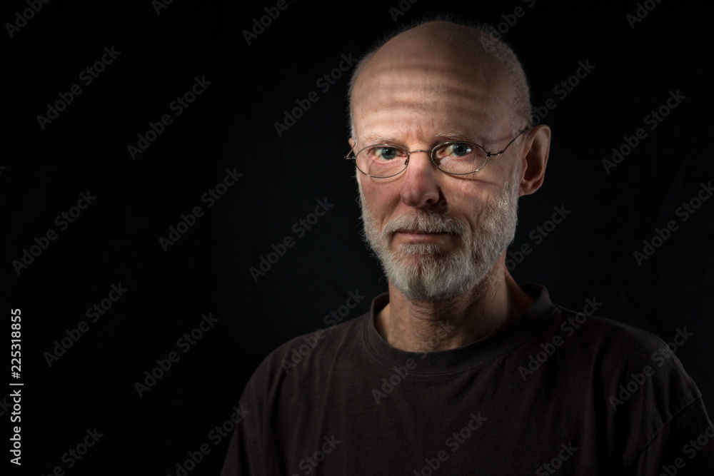 portrait of wondering senior man on black background portrait of wondering senior man on black background
