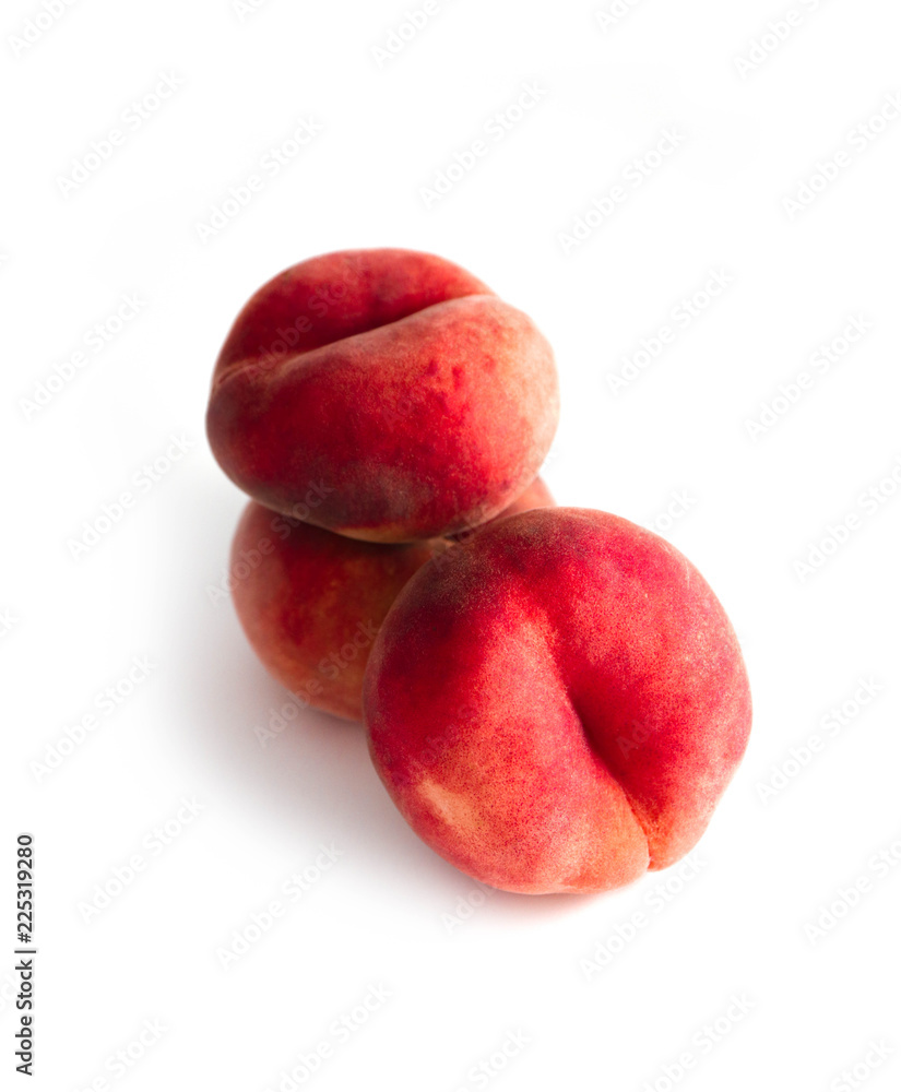 Saturn Peach isolated on white background. Flat peaches, tree doughnut peaches in a pile. Saturn Peach isolated on white background. Flat peaches, tree doughnut peaches in a pile.