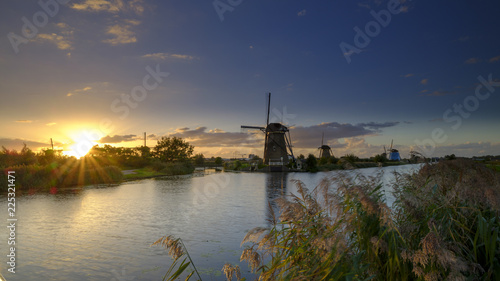 Autumn golden hour light on the windmills, canals and polders of Kinderdijk, near Rotterdam, Netherlands