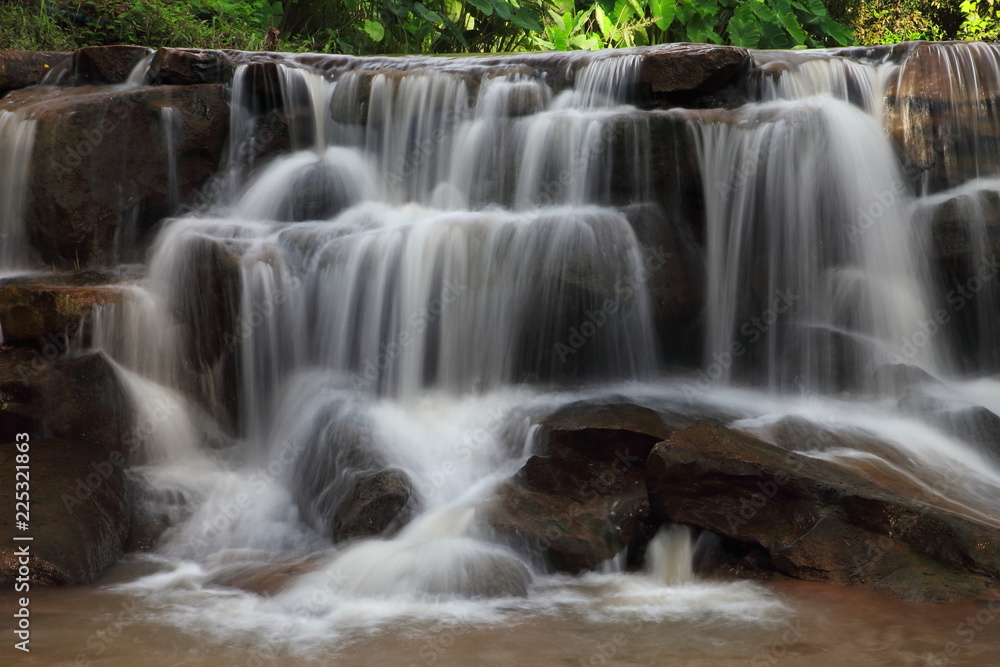 Cascading waterfall in rainy season deep inside the tropical forest of Thailand