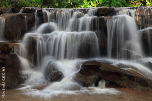 Cascading waterfall in rainy season deep inside the tropical forest of Thailand © Akarawut
