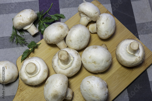 Fresh champignons on a cutting board, ready for cooking, vegan food.