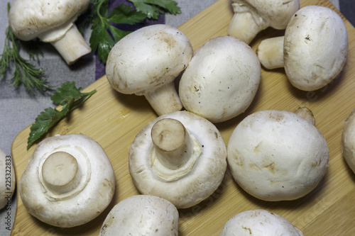 Fresh champignons on a cutting board, ready for cooking, vegan food.