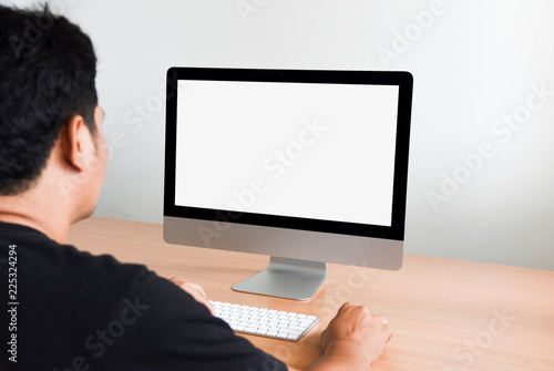 Young man working on Computer screen with blank copy space screen for your advertising text message in office