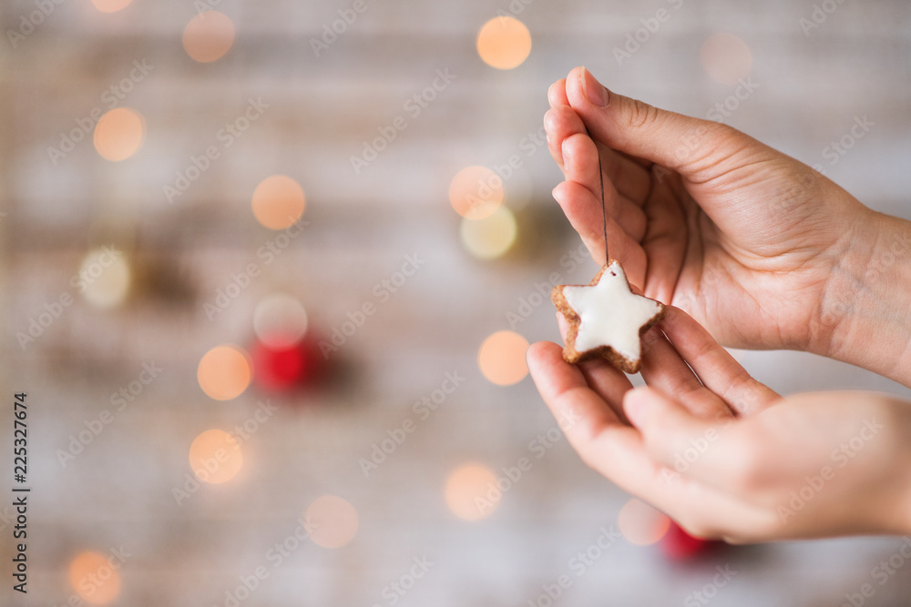 Female hands holding Christmas decorations. Copy space.