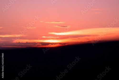 purple orange sky and sunlight and Silhouette black Long mountain in evening time © ananaline
