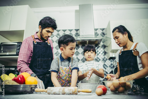 Happy family have a good time cooking together in the kitchen at home. Family concept.