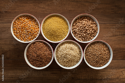 Whole foods diet base - various seeds in bowls on brown table