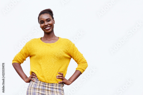 smiling young african american woman posing against isolated white background