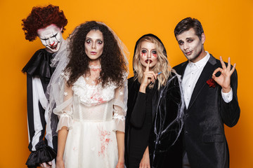 Group of friends dressed in scary costumes celebrating