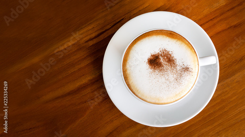 Fotografie Hot coffee cappuccino latte top view on wooden background