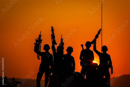 twilight landscape silhouette military and hand holding gun