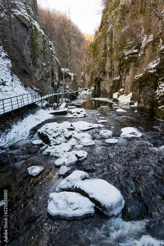 Snow covered rocks in the gorge of the Devinska river in Bulgaria during winter photo