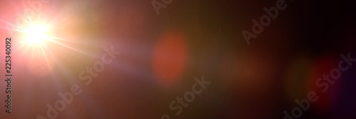 golden screen lens flare effect overlay texture in shades of orange and red with bokeh in front of a black background banner