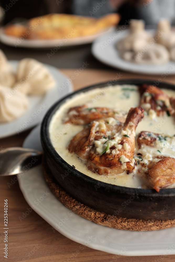 Chicken in a creamy sauce with garlic and herbs, khinkali. Chicken in a creamy sauce with garlic and herbs, khinkali.