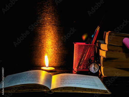 Book,Accessories,pencils, with lighting candle at night time,Back to School,Education concept,