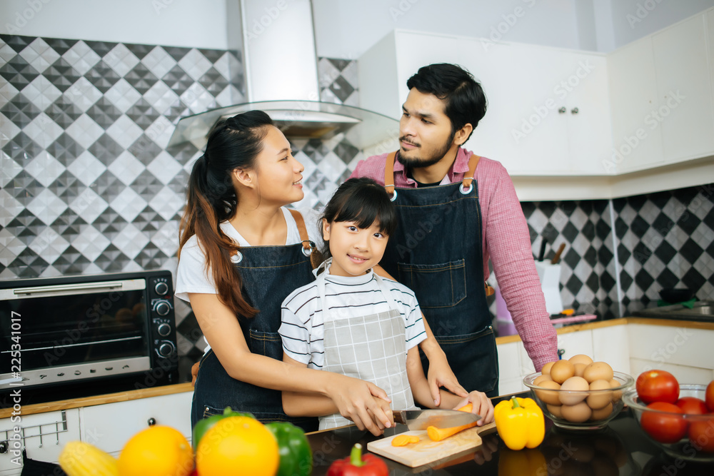 Family cooking time : Happy mum teach her daughter chopping vegetable preparing ingredients for cooking meal in kitchen at home. Family cooking time : Happy mum teach her daughter chopping vegetable preparing ingredients for cooking meal in kitchen at home.