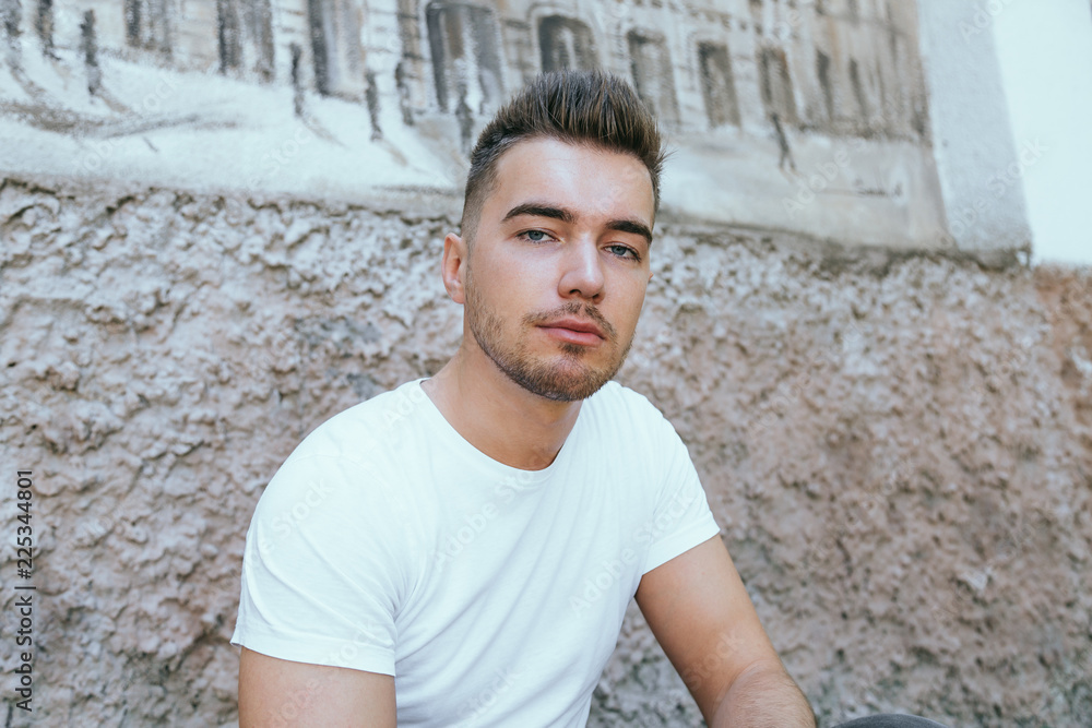Man portrait look at camera in a white T-shirt Man portrait look at camera in a white T-shirt