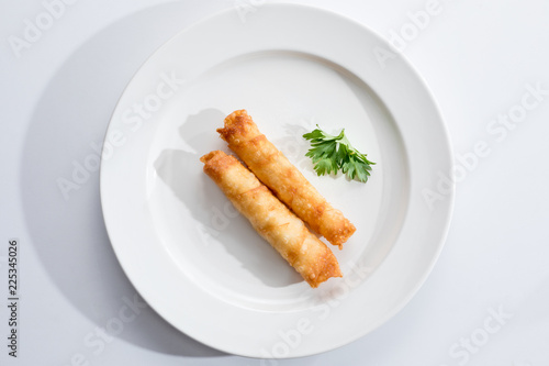 Cigar Pastries on a white plate.