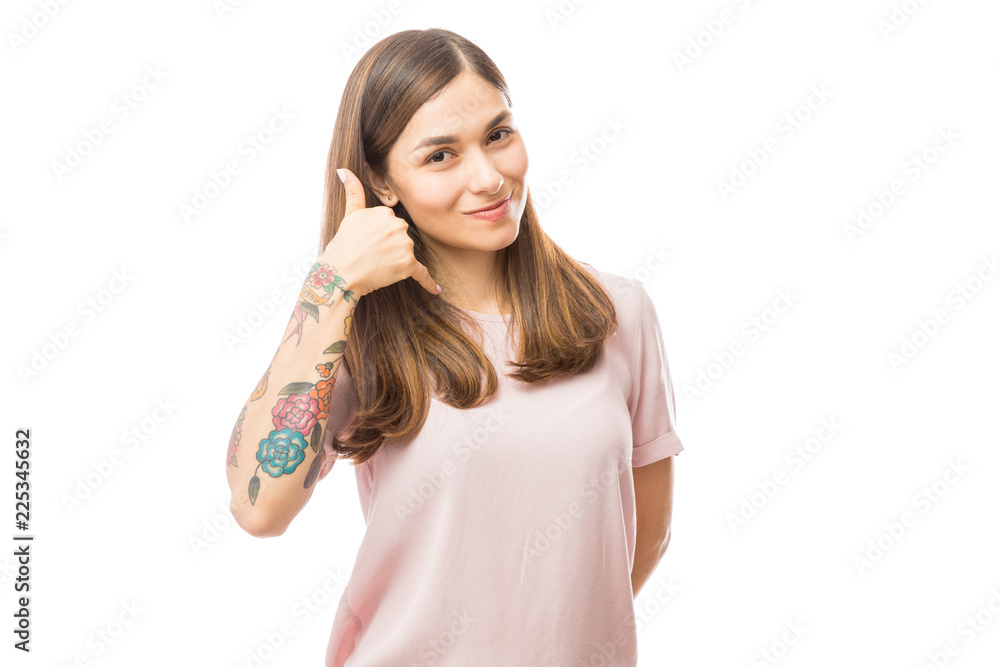 Woman Showing Call Me Gesture Against White Background Woman Showing Call Me Gesture Against White Background