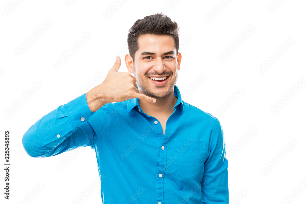 Smiling Man Showing Call Me Gesture On White Background Smiling Man Showing Call Me Gesture On White Background