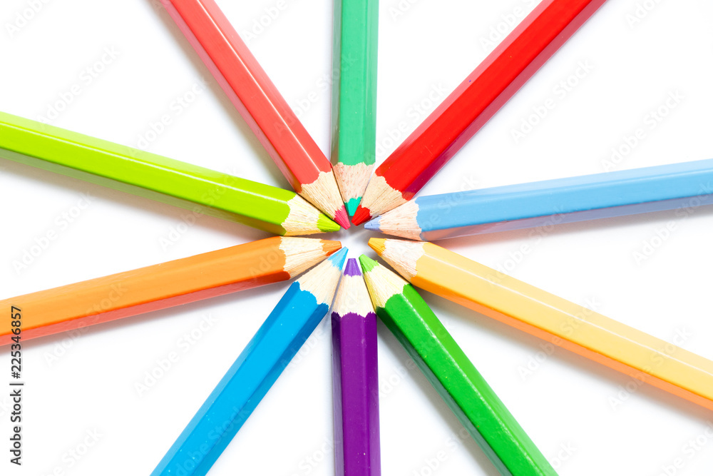 Color pencil arrange in ray shape on white paper background
